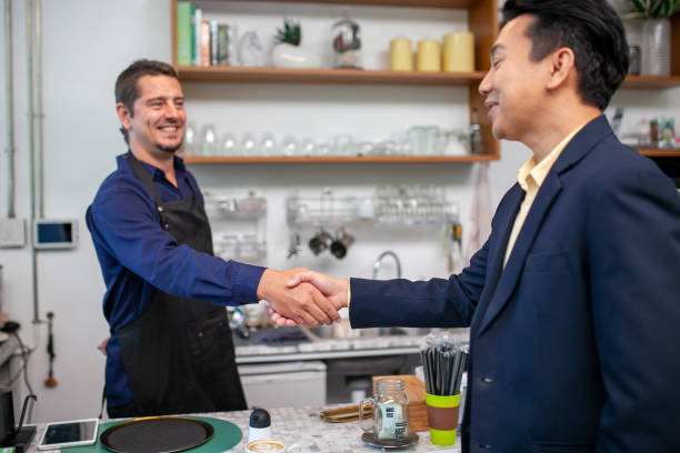 Barista and salesman shaking hands